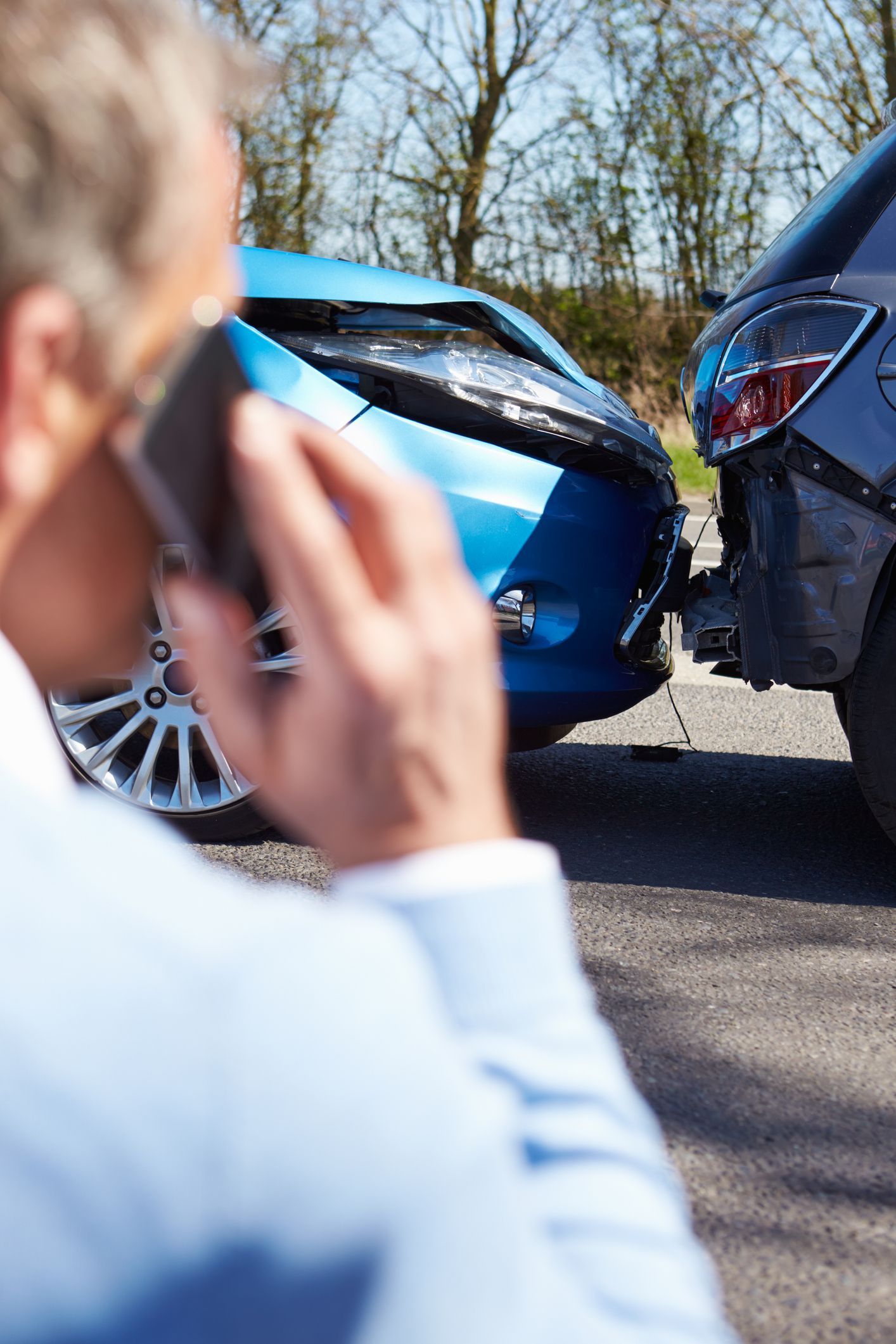 Driver making a phone call to his car insurance.