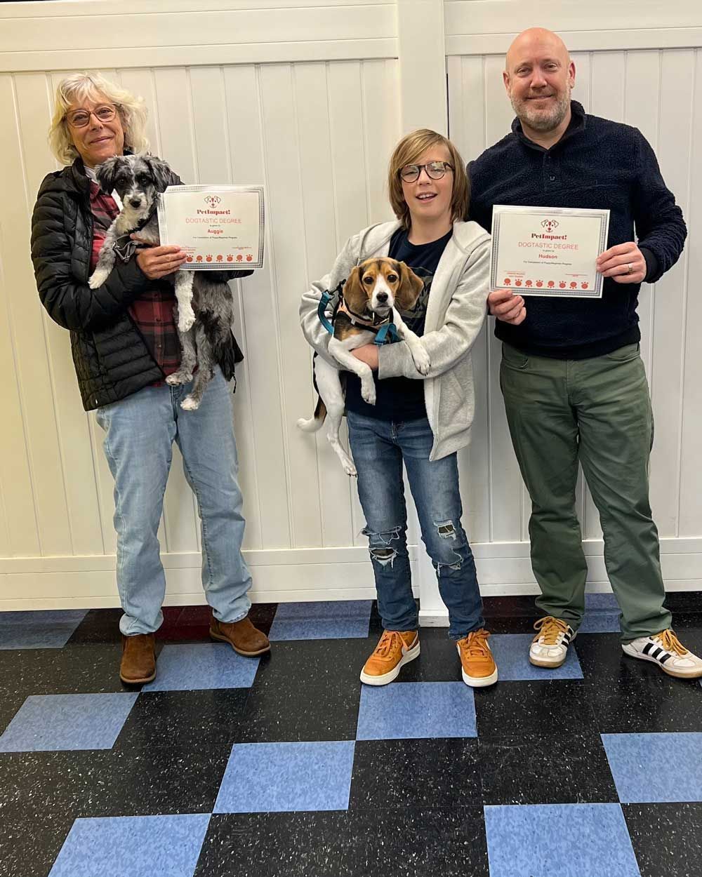 Pet Owners Holding a Certificate — St. Louis, MO — PetImpact!