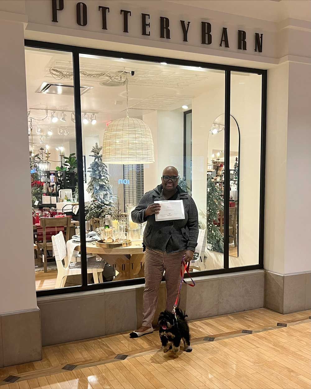 Man Holding His Dog's Certificate — St. Louis, MO — PetImpact!