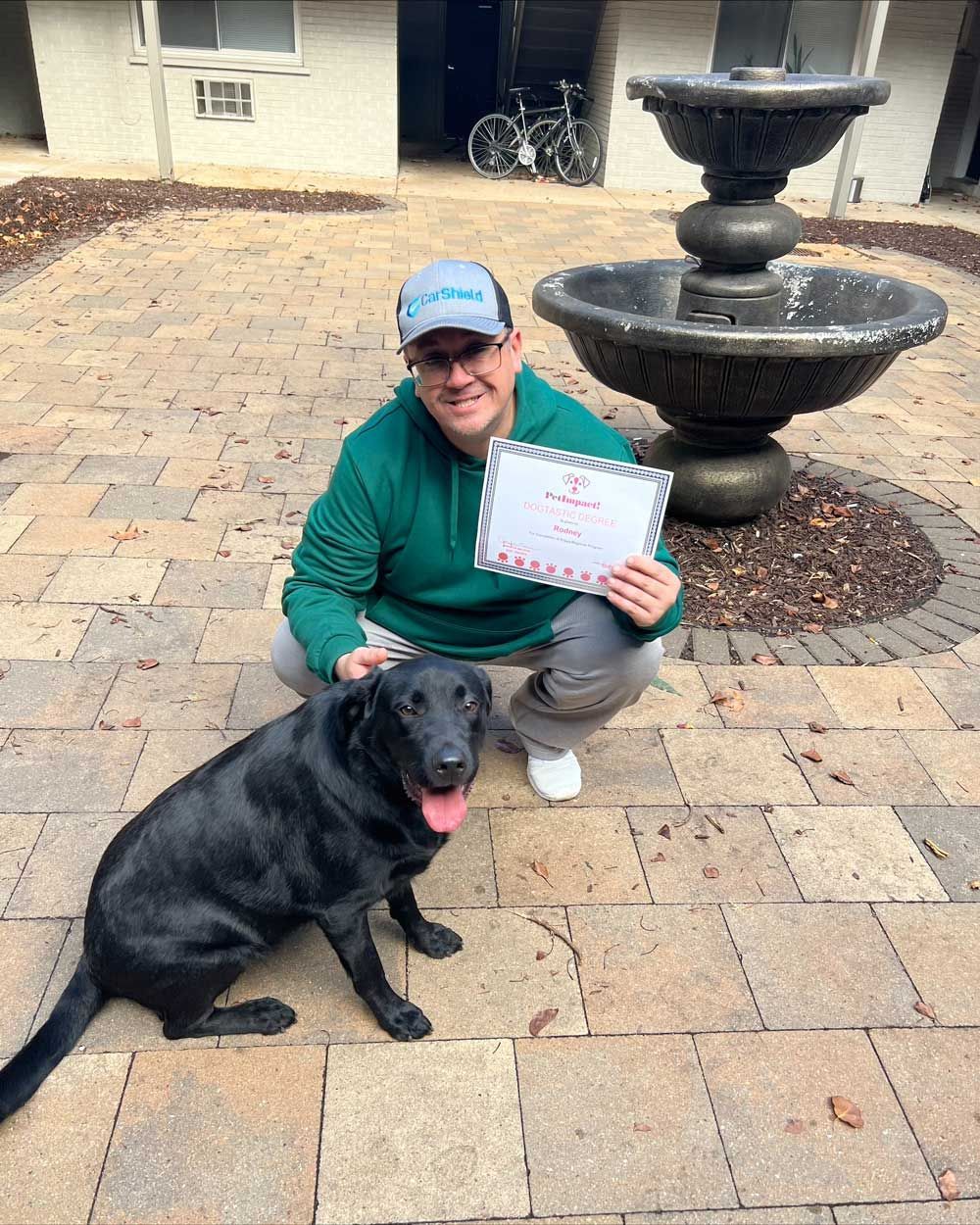 Man Wearing Green Hoodie with His Dog — St. Louis, MO — PetImpact!