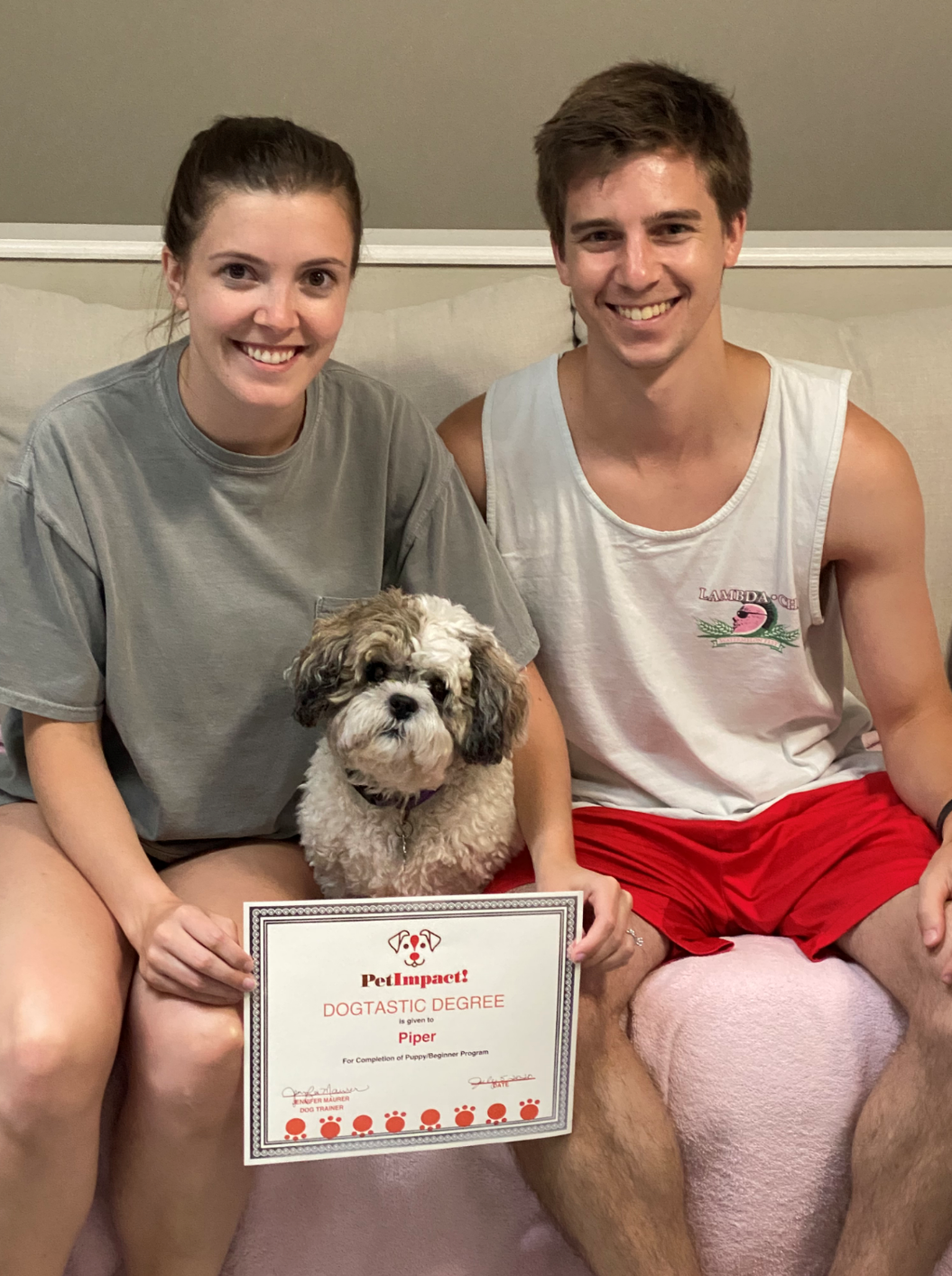 Couple with small dog holding a 