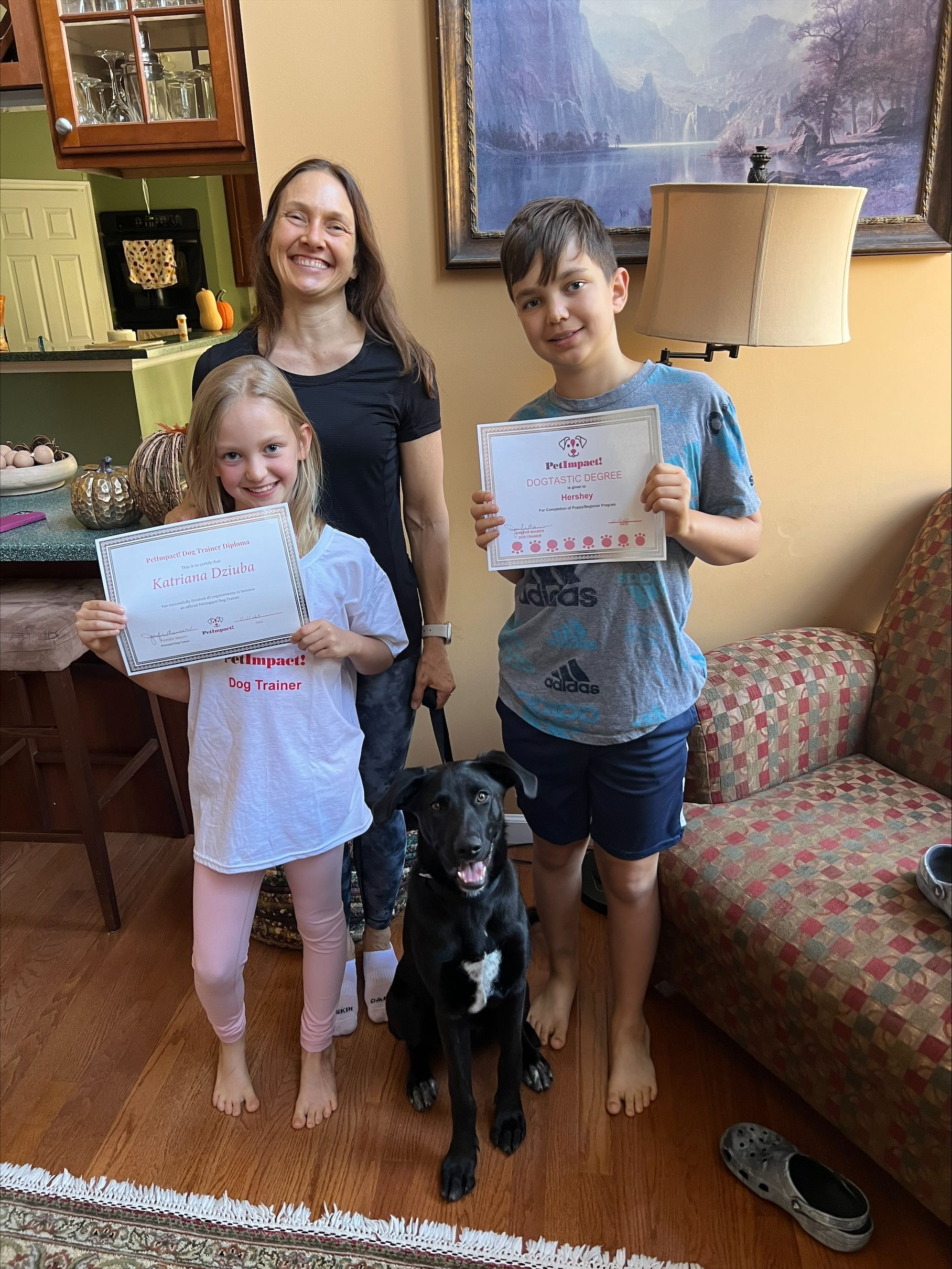 A mother and children holding the certificates — St. Louis, MO — PetImpact!