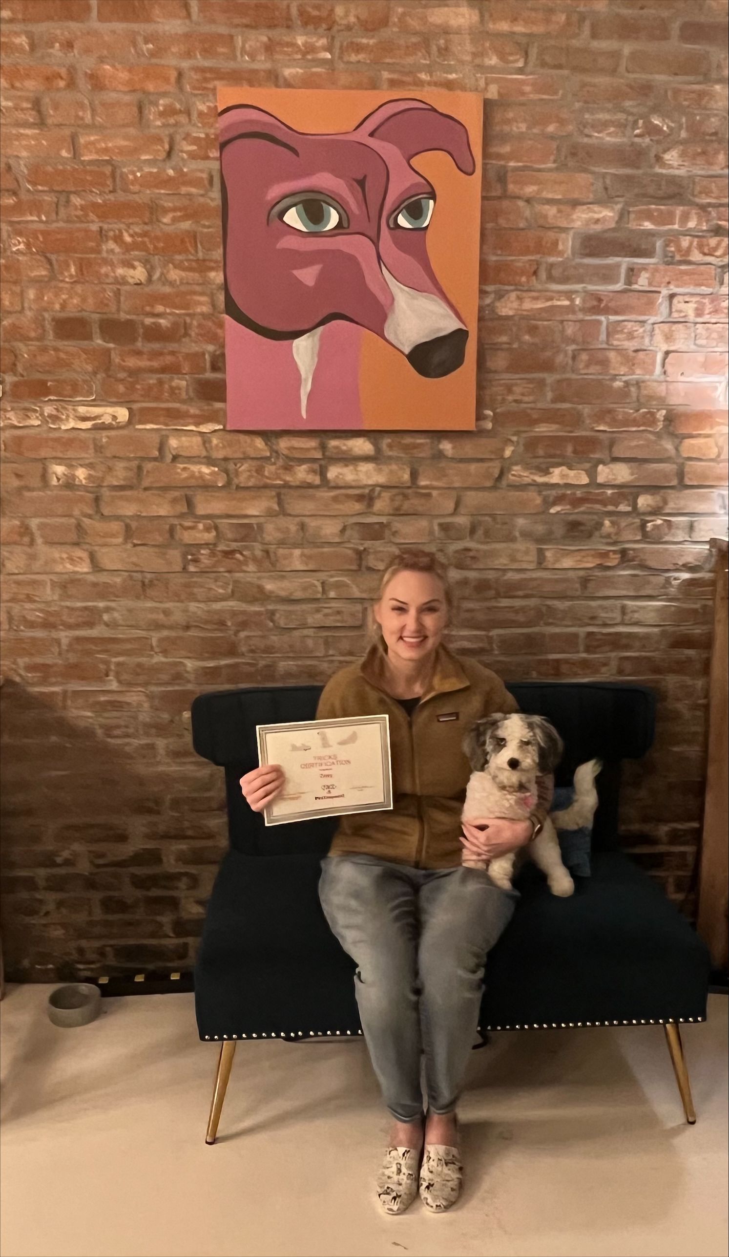 A girl hugging a dog while holding a certifiacate — St. Louis, MO — PetImpact!