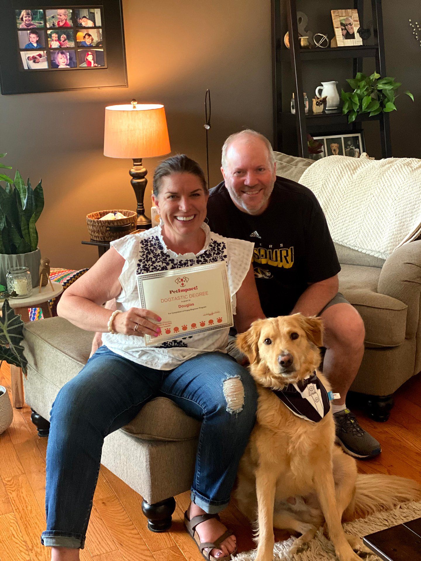 Dog and Couple Holding Certificate — St. Louis, MO — PetImpact!