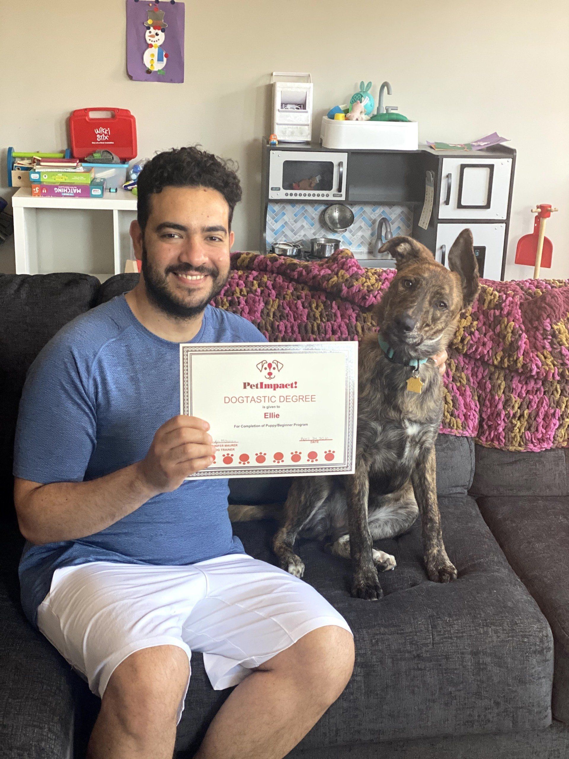 Dog Ellie With Its Owner Holding Certificate — St. Louis, MO — PetImpact!