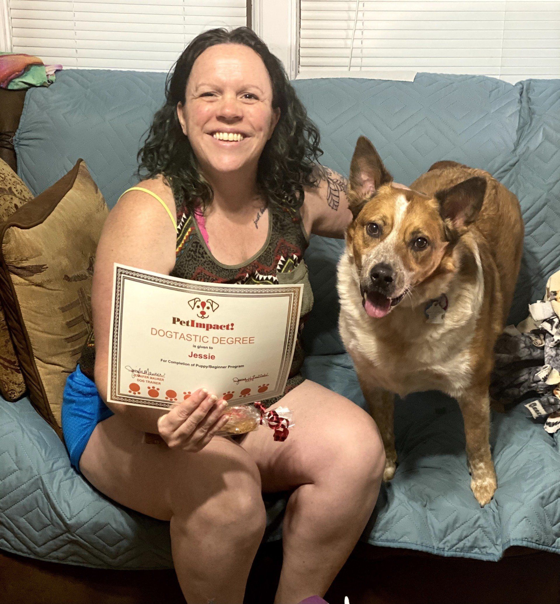 Dog Jessie With Its Owners Holding Certificate — St. Louis, MO — PetImpact!