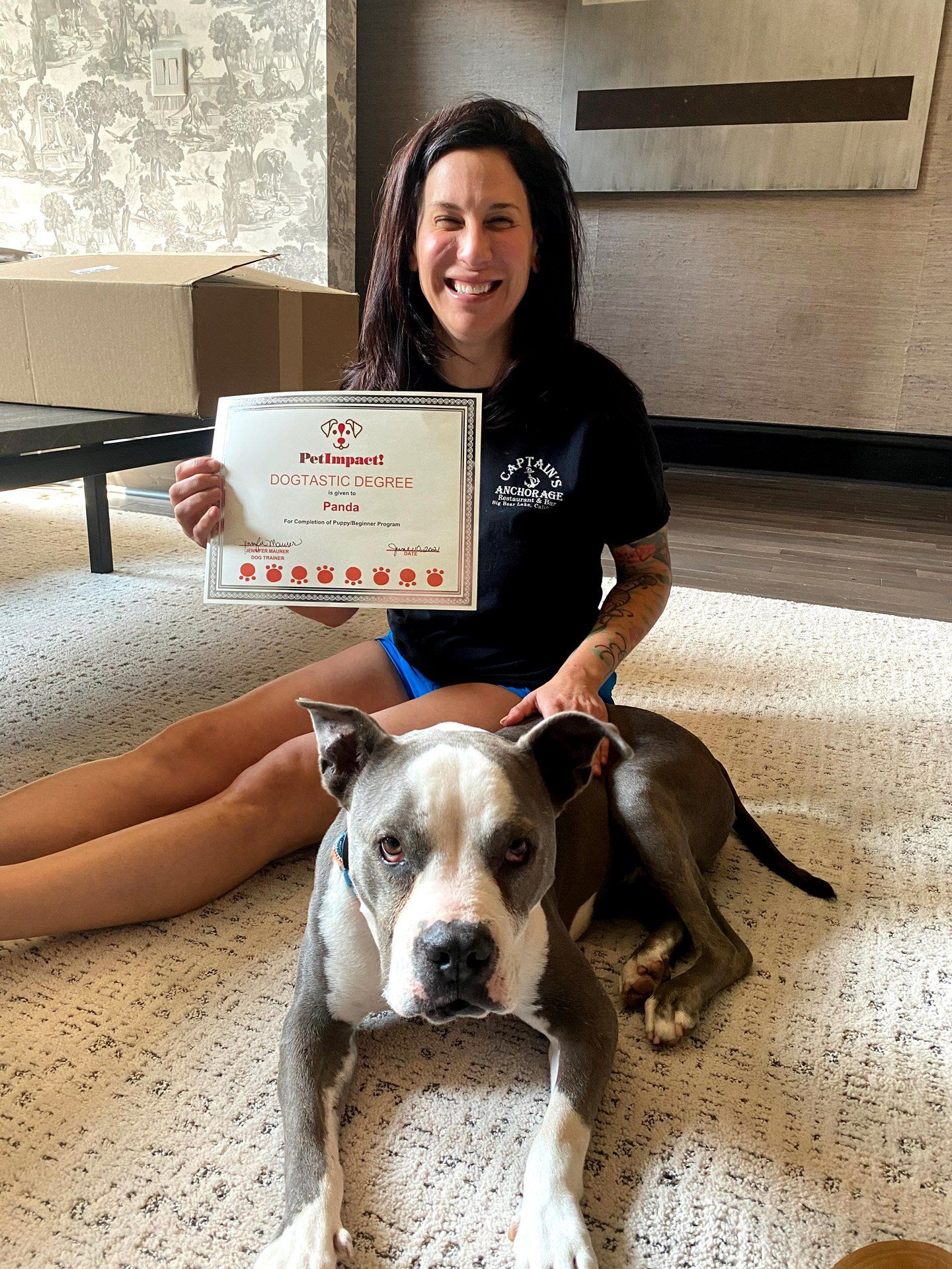 Dog and Woman Holding Certificate — St. Louis, MO — PetImpact!
