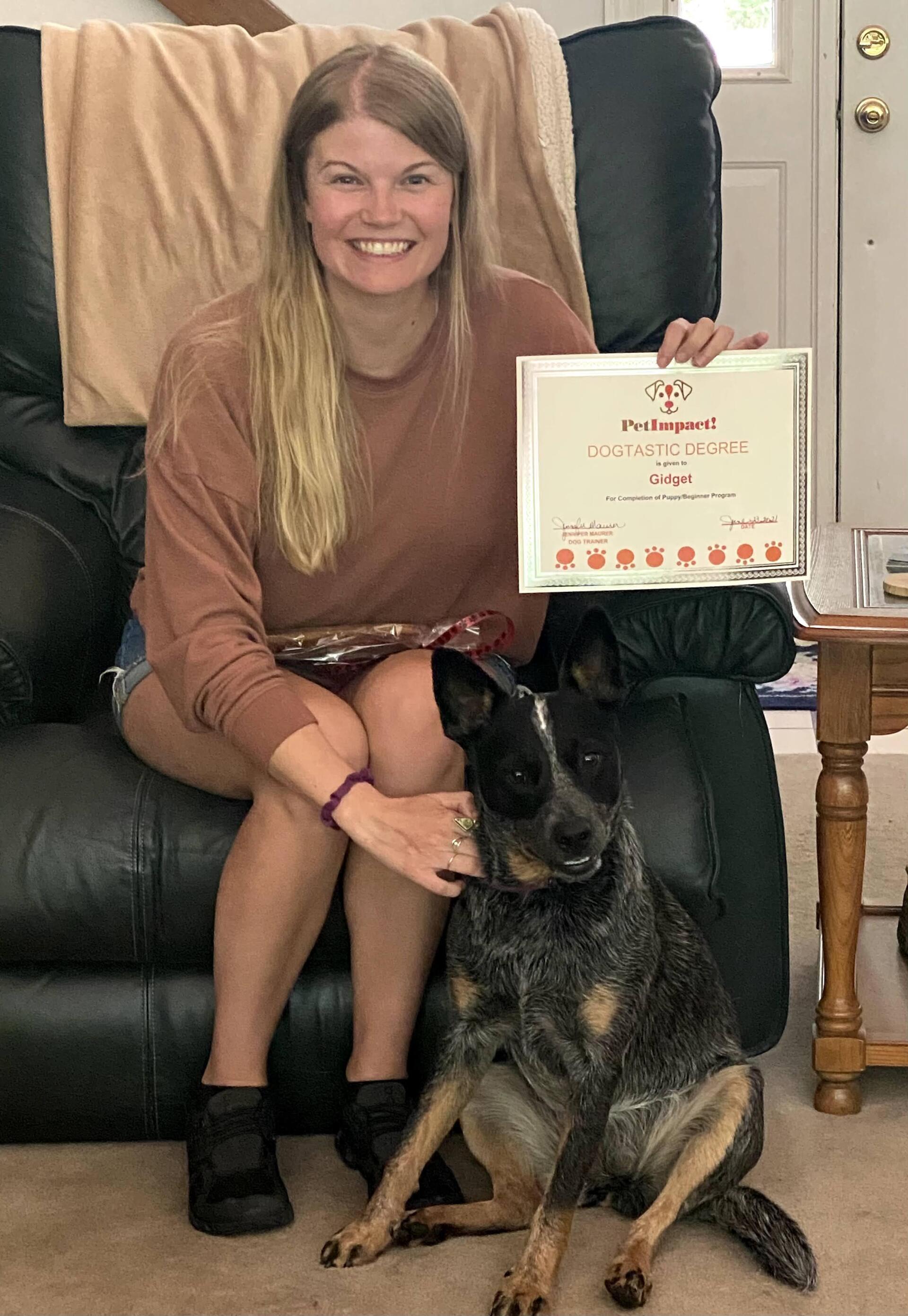 Dog Gidget With Its Owner Holding Certificate — St. Louis, MO — PetImpact!