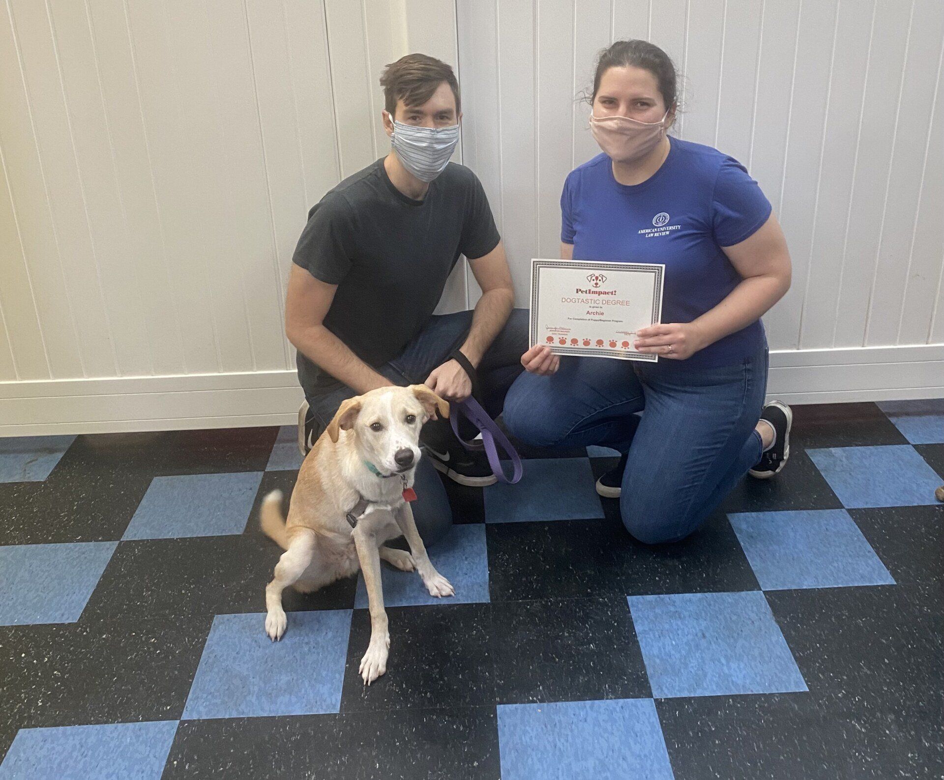 Dog Archie With Its Owner Couple Holding Certificate — St. Louis, MO — PetImpact!