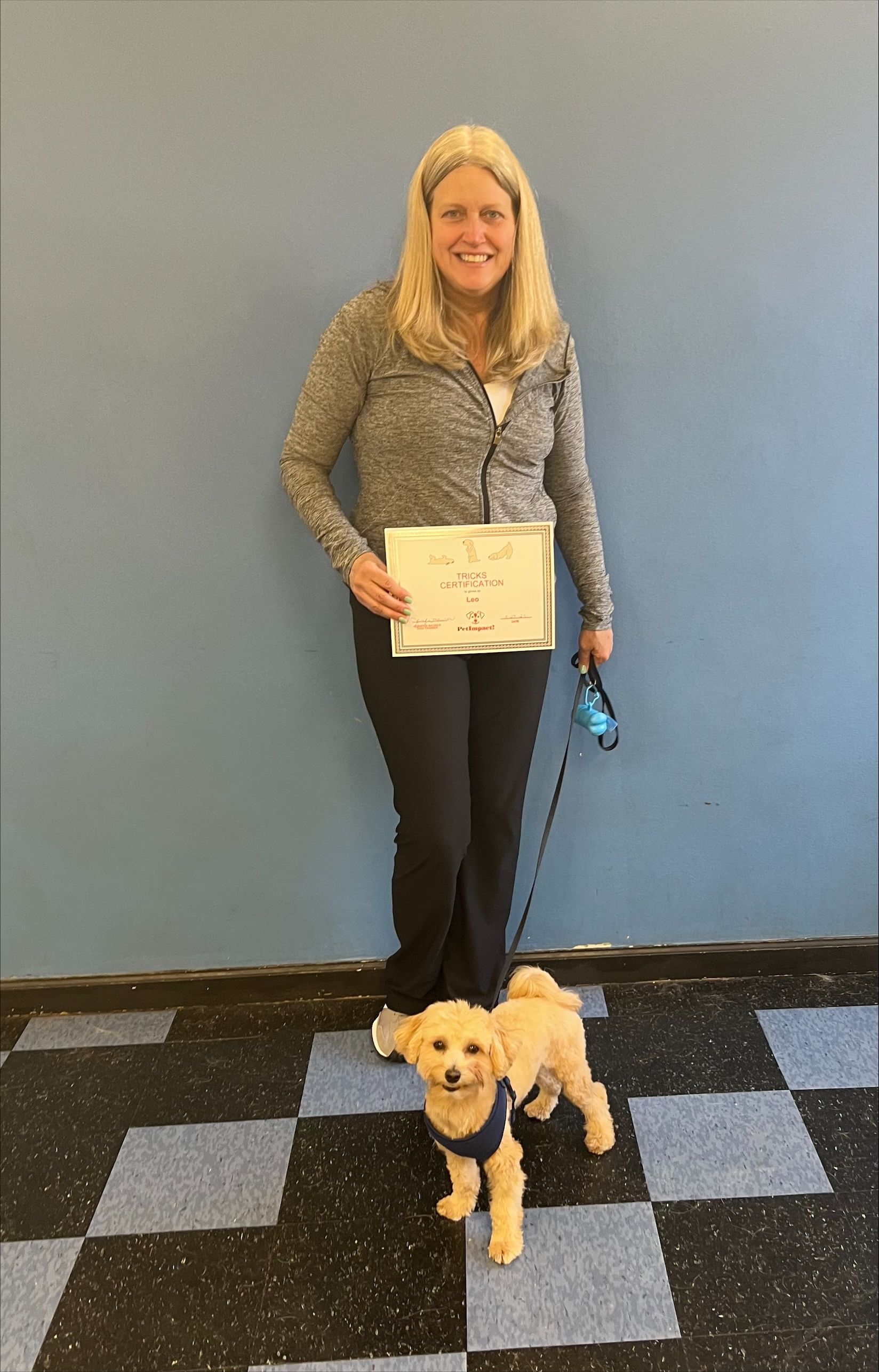 Woman in Gray Jacket Holding a Certificate With Her Dog — St. Louis, Mo — Petimpact!