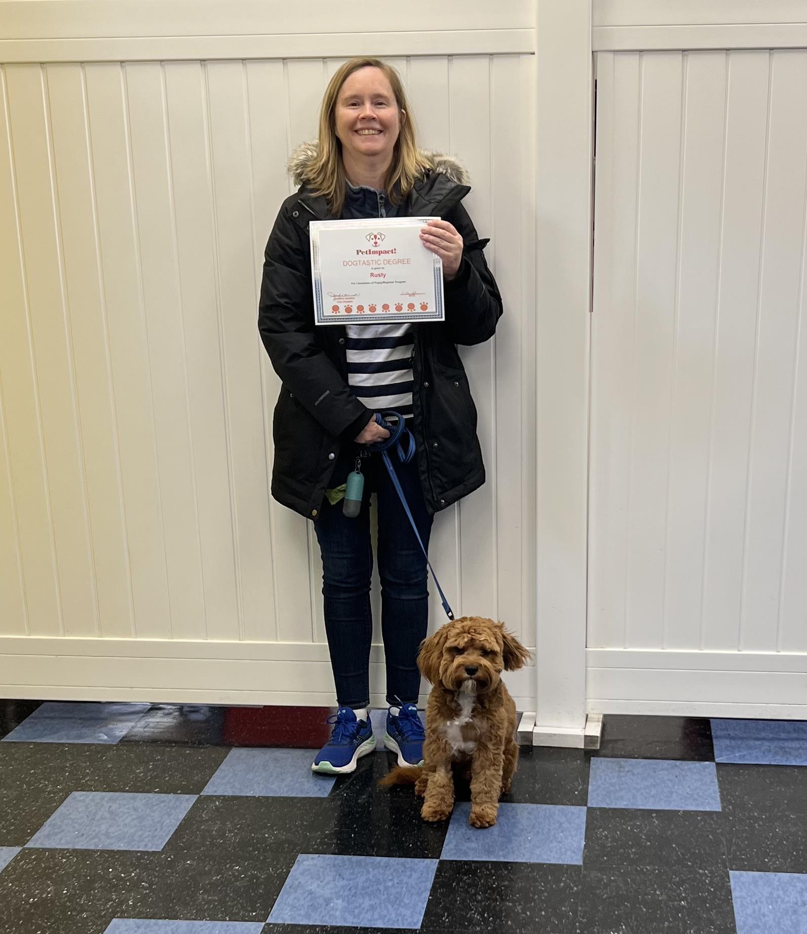 Dog Owner Holding A Certificate — St. Louis, MO — PetImpact!