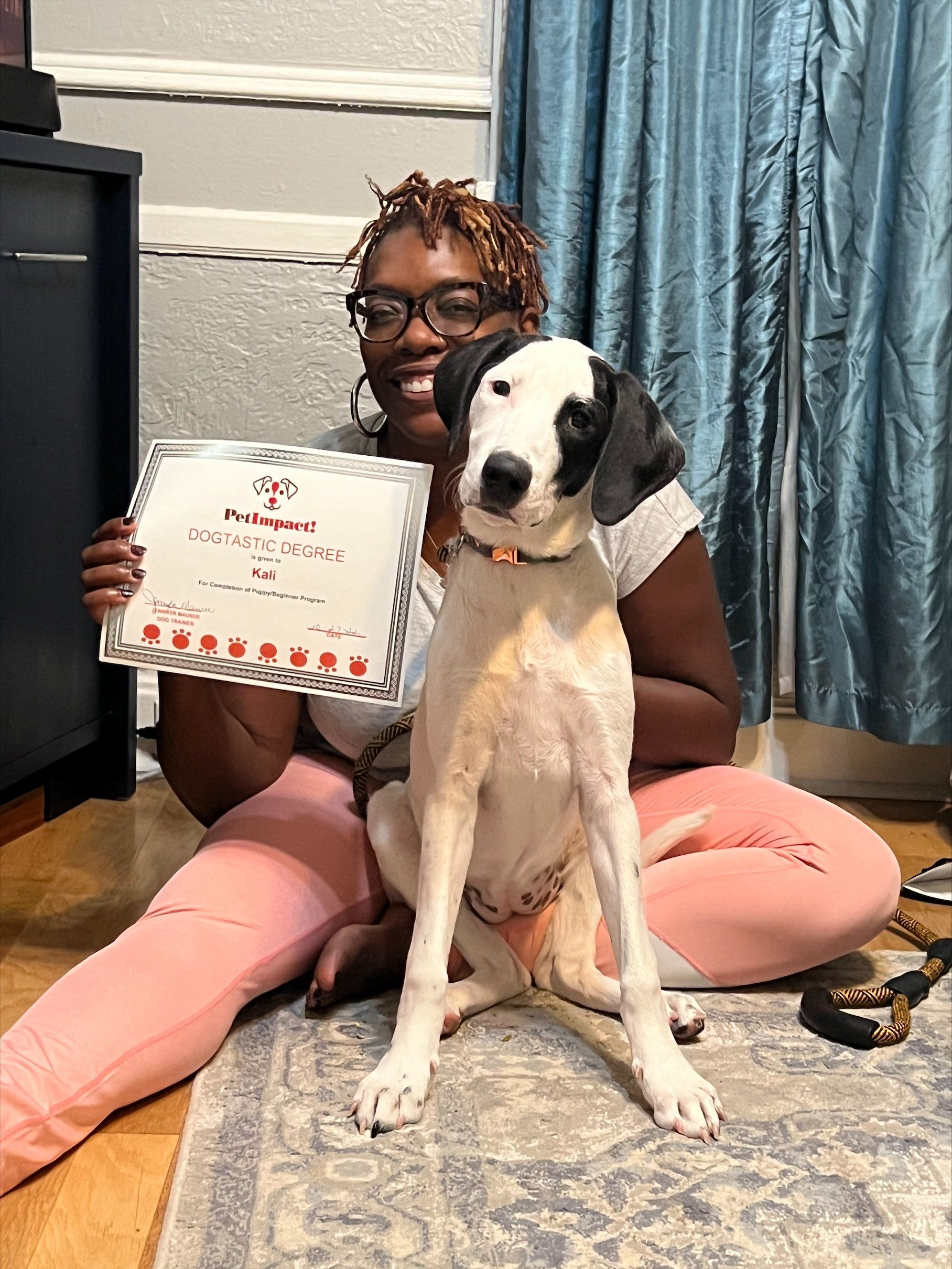 Close Up Photo of A Women Holding Her dog Certificate — St. Louis, MO — PetImpact! Dog Training