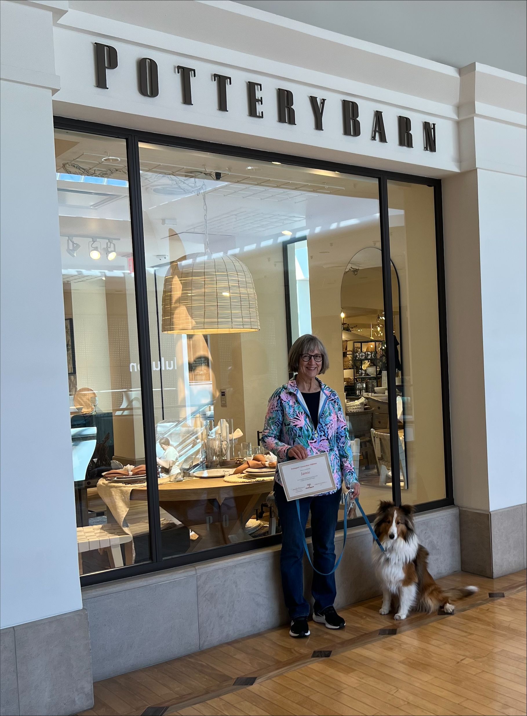 Woman in Blue Holding a Certificate With Her Dog — St. Louis, Mo — Petimpact!
