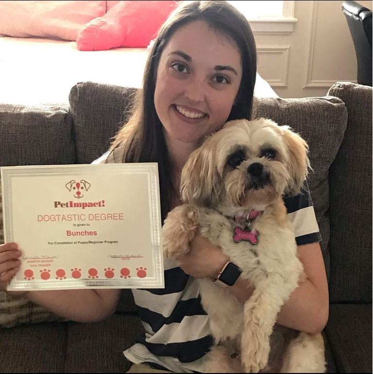 Woman holding a dog and a 