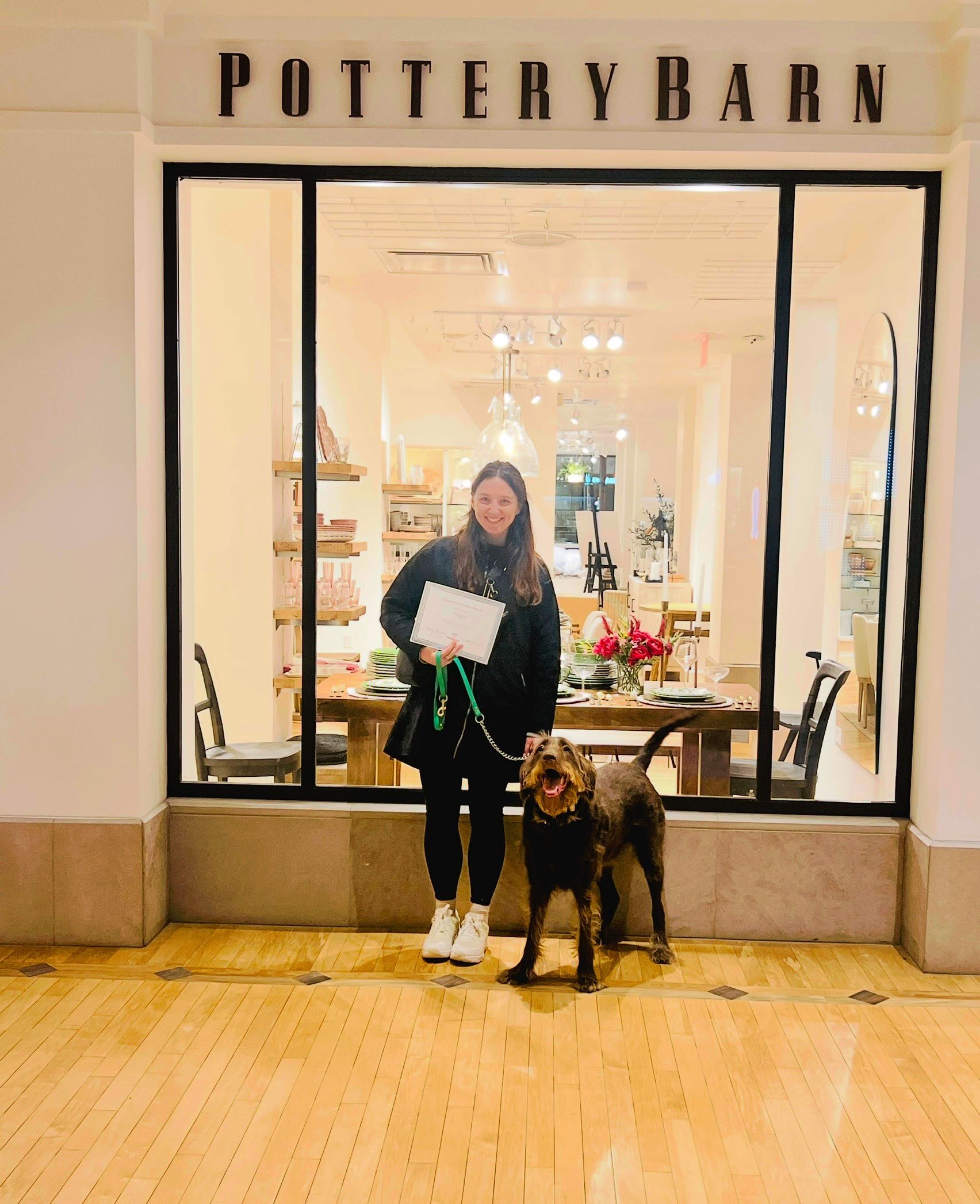 A woman standing next to a dog 