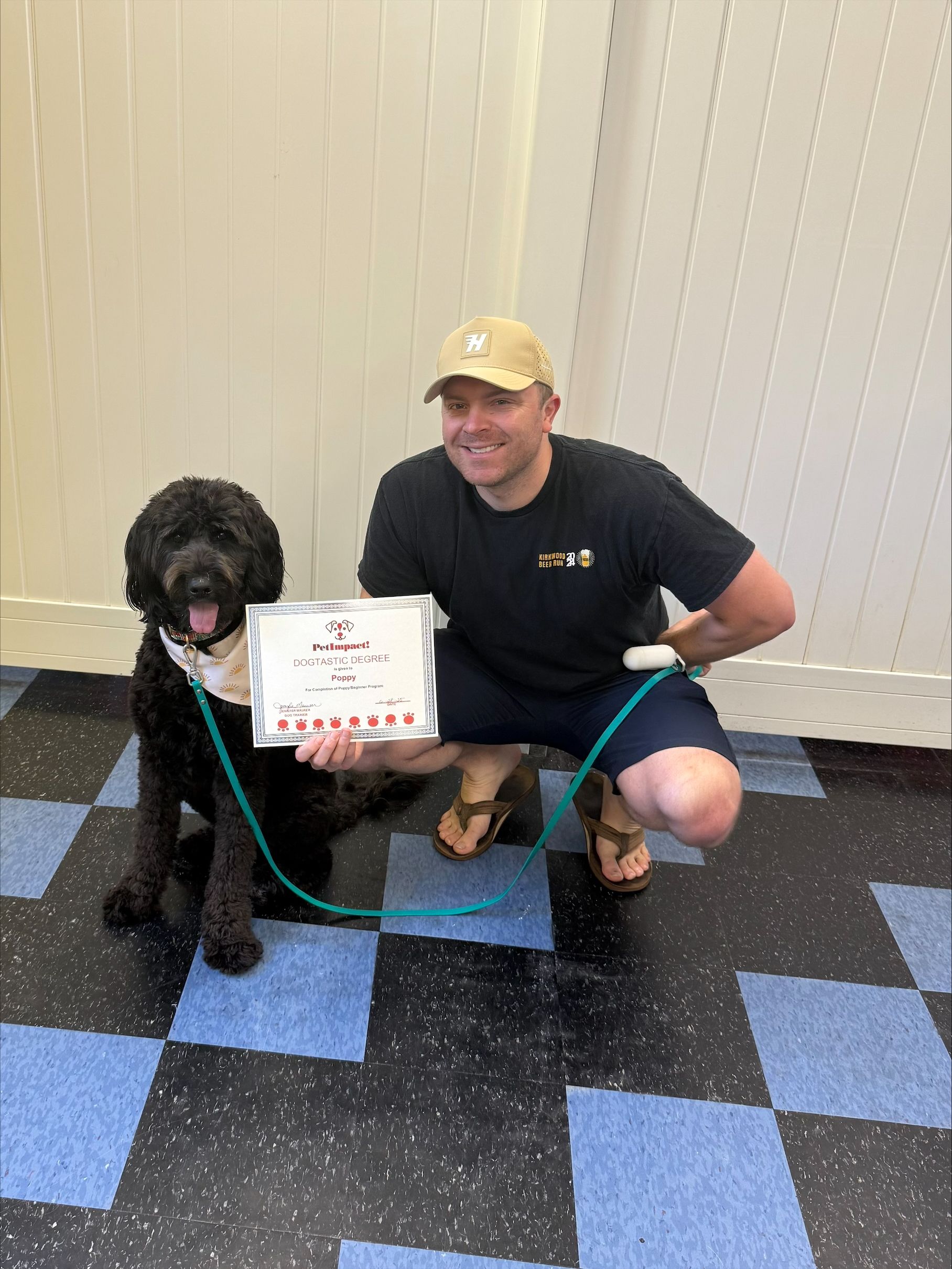 A woman is holding a dog in her arms and holding a certificate.
