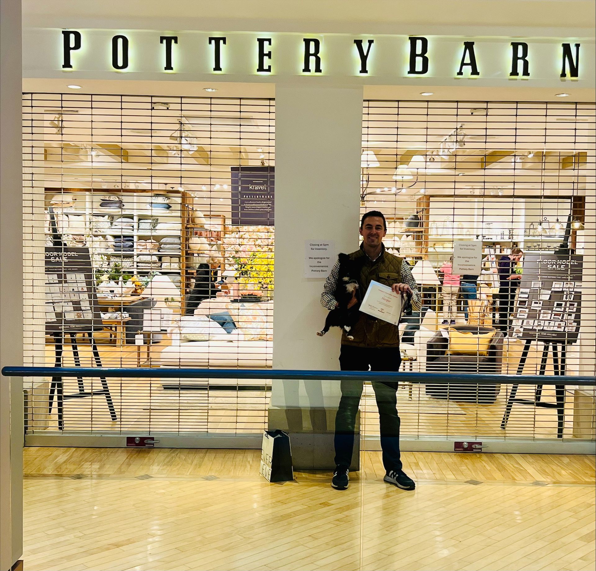 A man standing in front of a pottery barn store