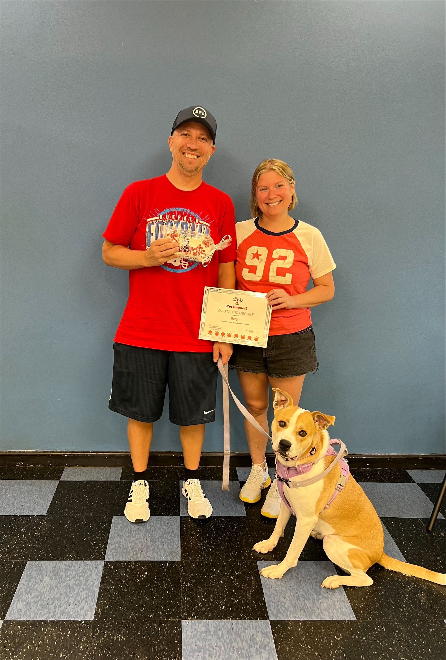 A Man and a Woman Are Standing Next to a Dog — St. Louis, MO — PetImpact!