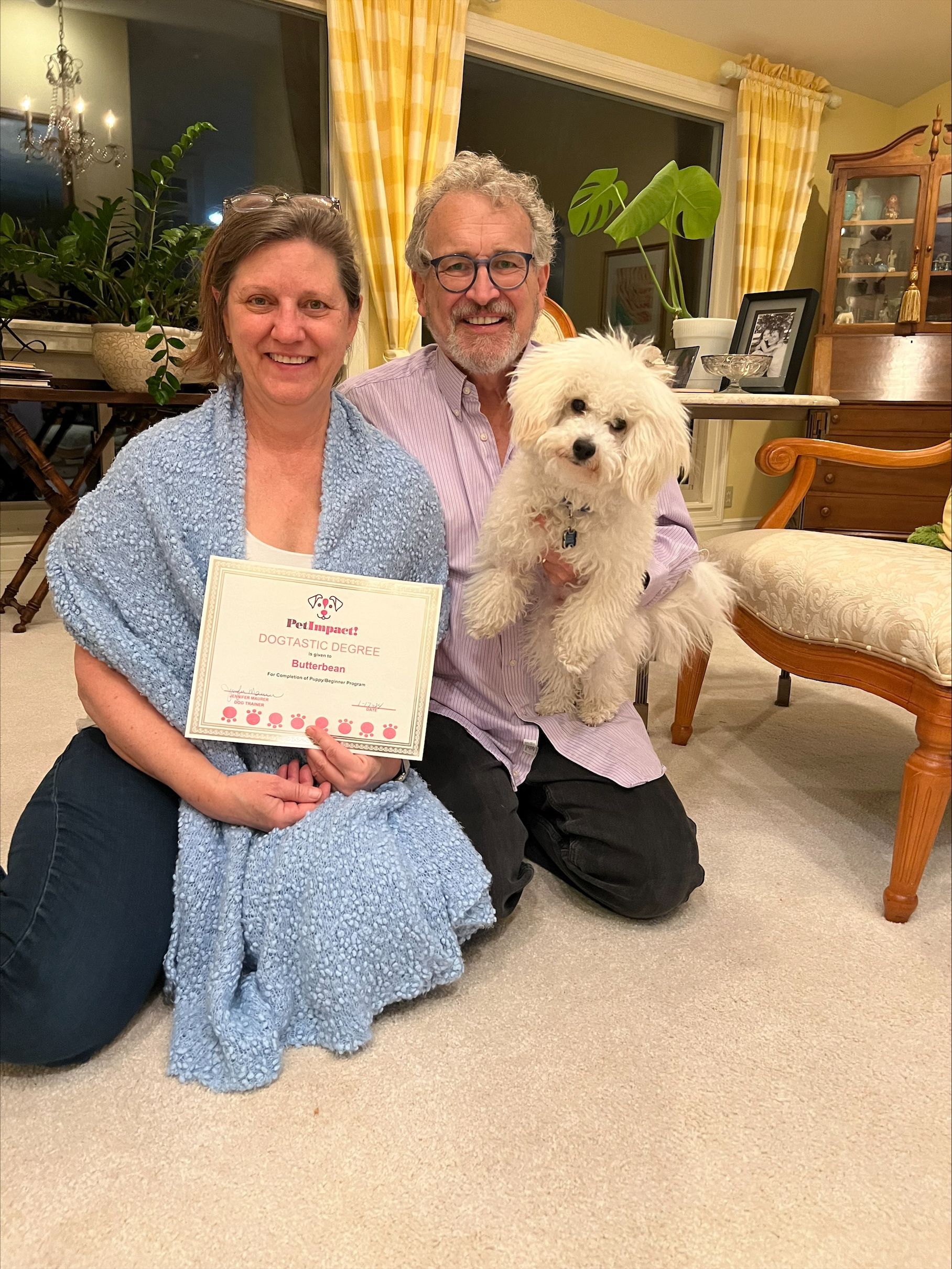 A Man Holding A White Dog And A Woman Holding A Certificate — St. Louis, MO — PetImpact!