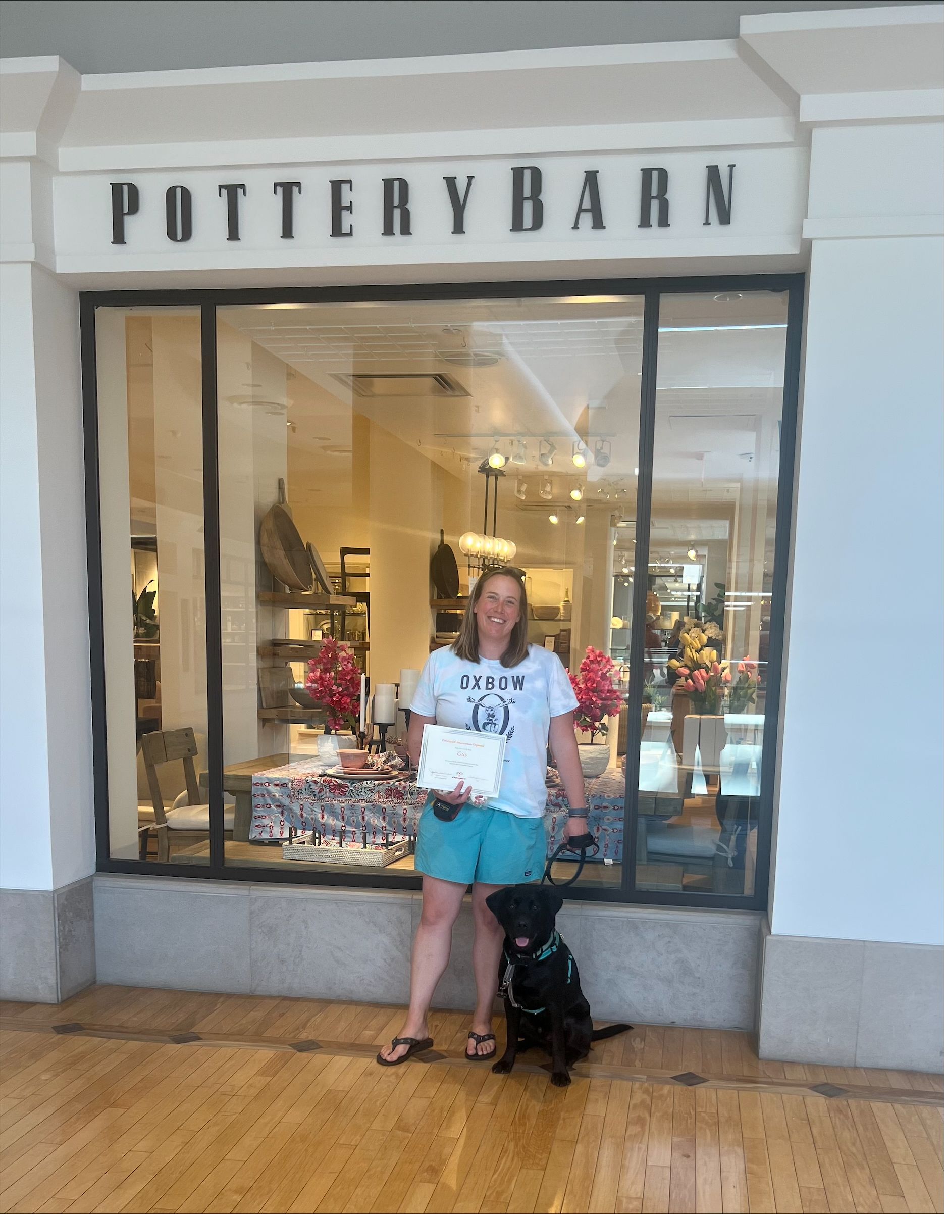 A woman standing in front of a pottery barn store