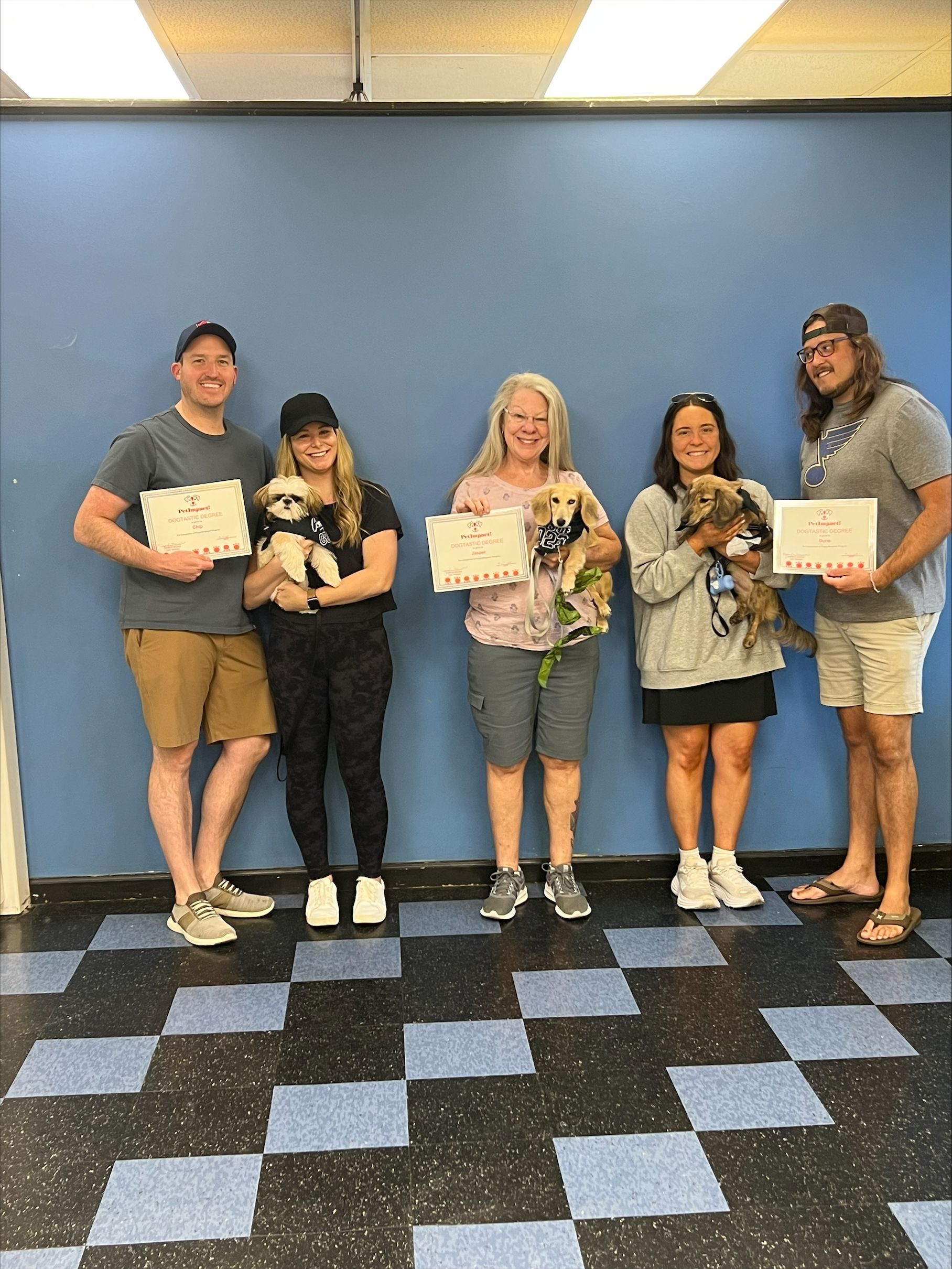 A Group of Fur Owner Holding Dog Certificate — St. Louis, MO — PetImpact!