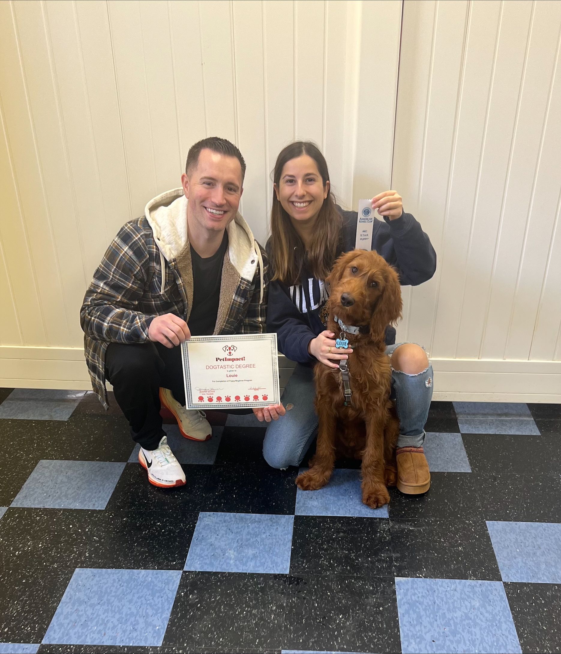A man and a woman are posing for a picture with a dog.
