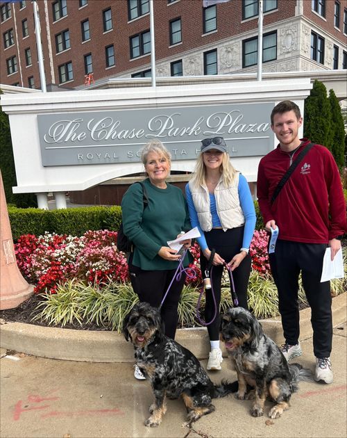 A group of people standing in front of a sign that says the chase park plaza