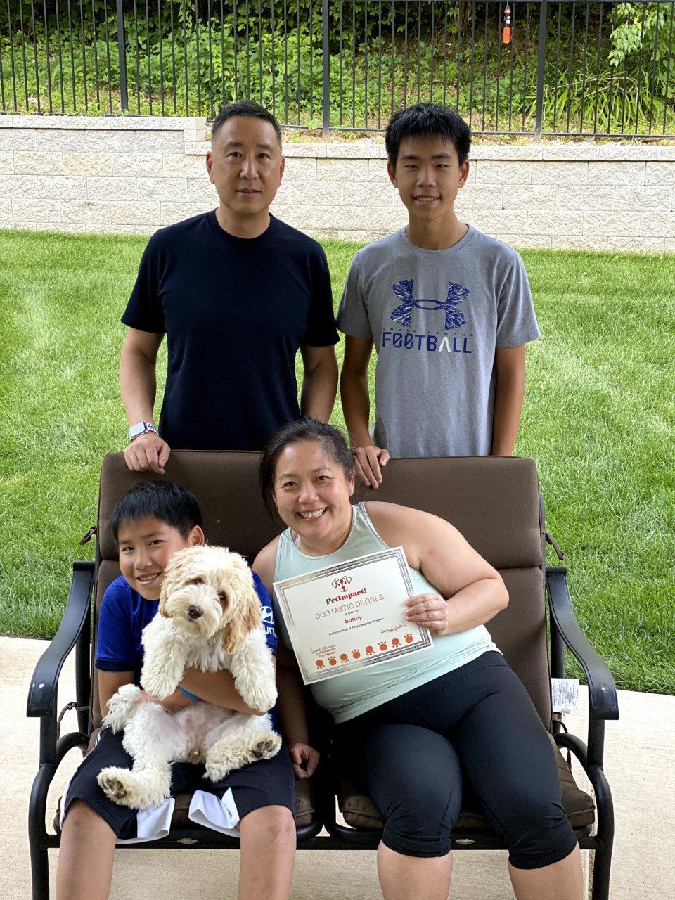 Dog Sunny With Its Family Owner Holding Certificate — St. Louis, MO — PetImpact!