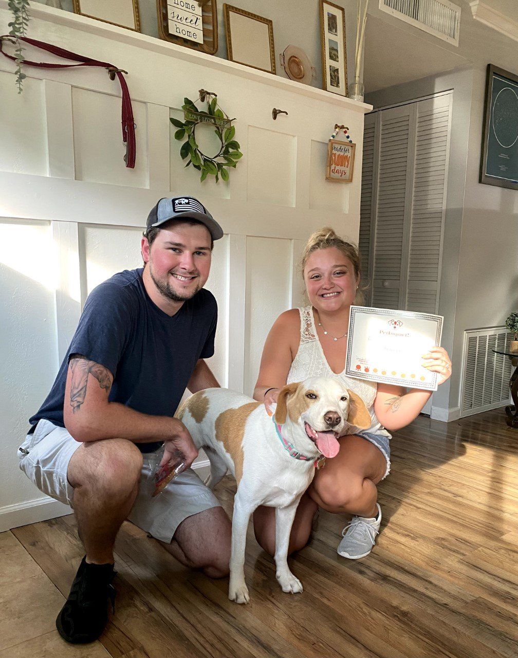 Dog With Its Happy Owner Couple Holding Certificate — St. Louis, MO — PetImpact!