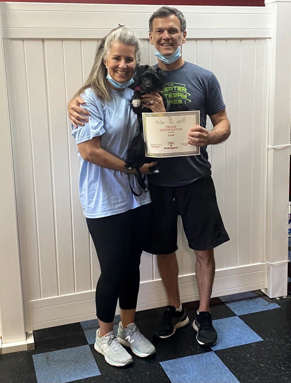 Dog Luna With Its Owner Couple Holding Certificate — St. Louis, MO — PetImpact!