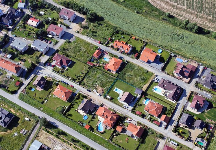 Casa con valla amarilla y cartel inmobiliario