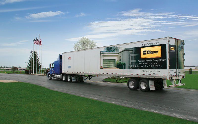 Semi-truck with a Chappy garage door advertisement on its side.