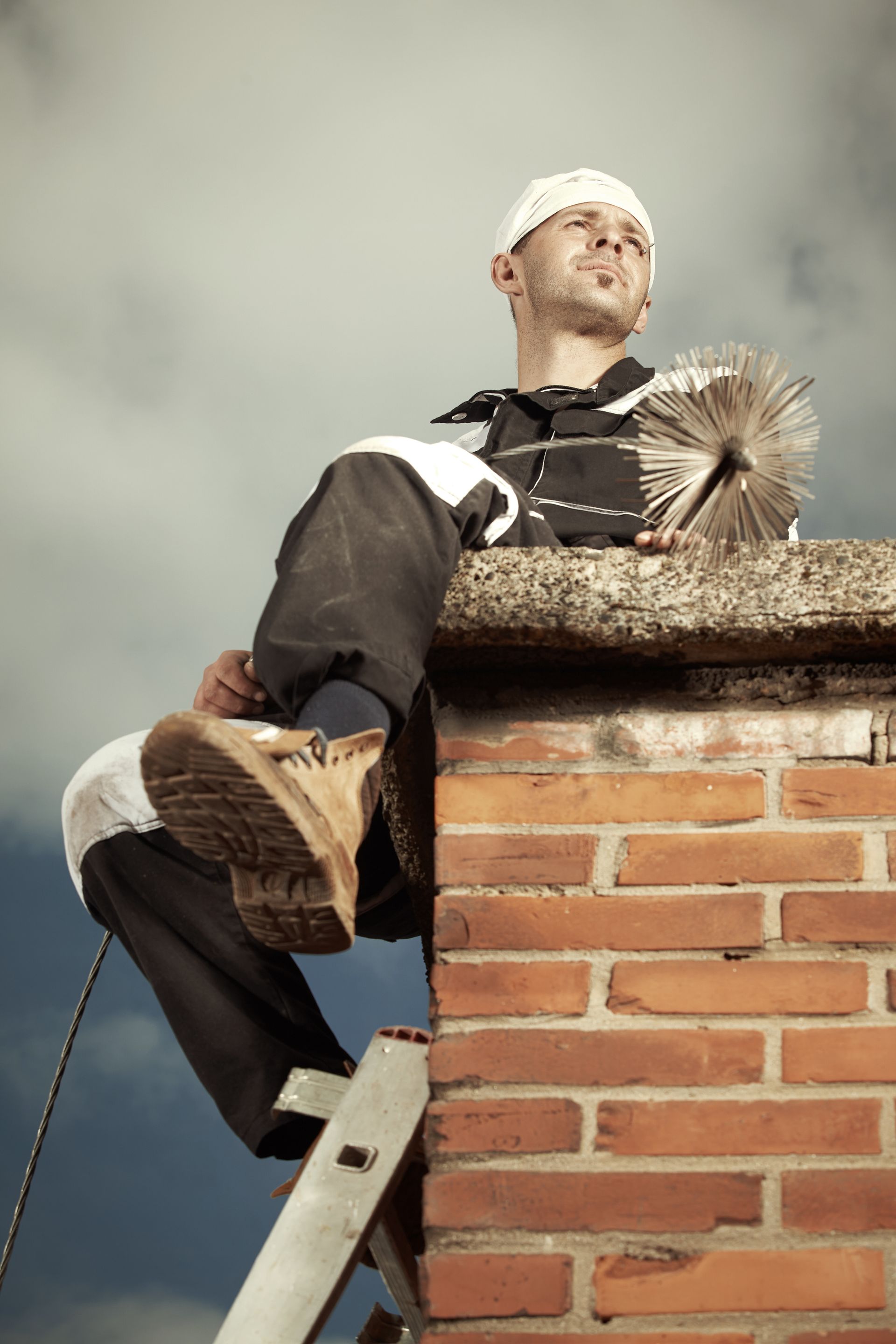 man sitting on top of chimney