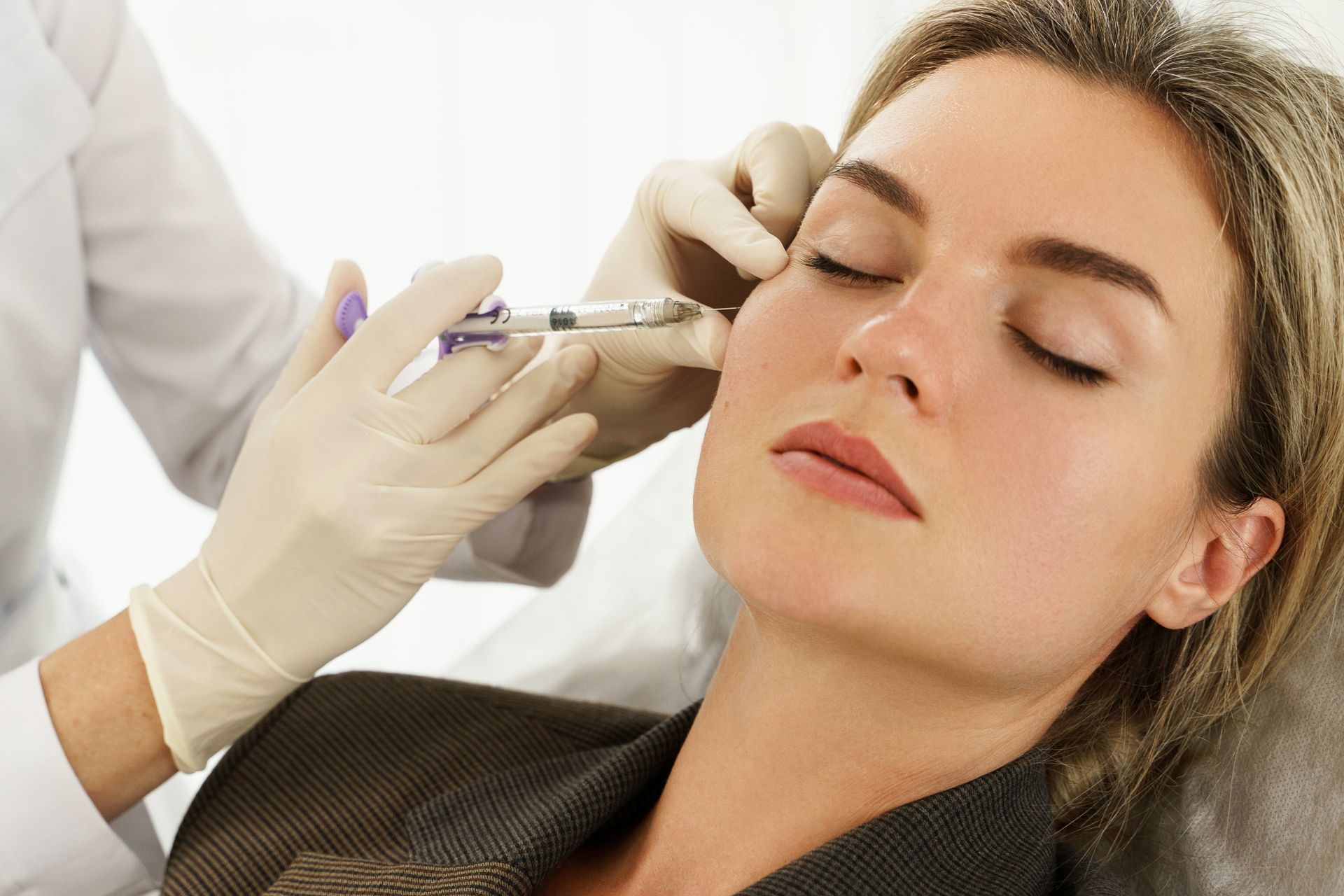 woman getting a cosmetic filler on her face