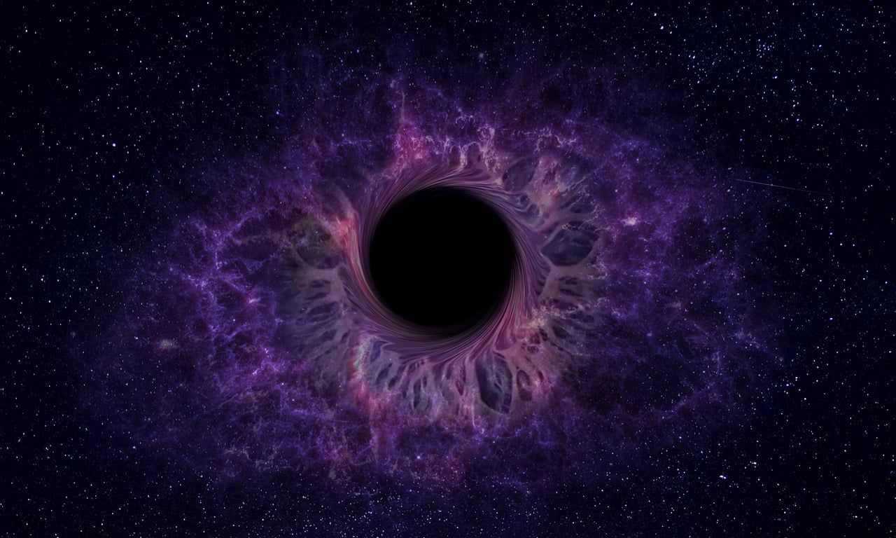 A black hole in the middle of a galaxy in space.