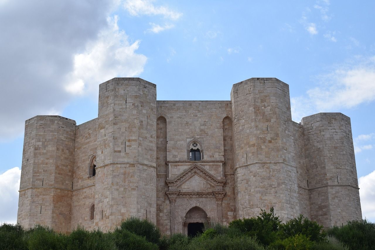 A large stone castle with a blue sky in the background.