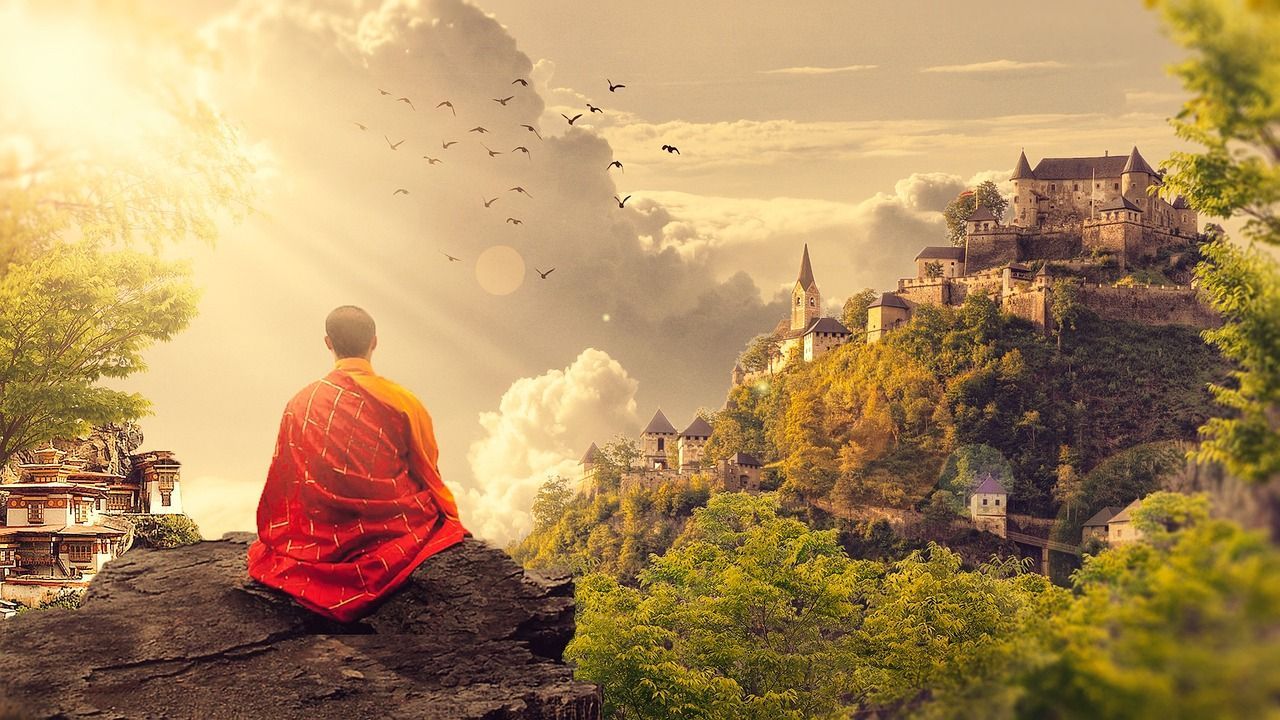 A monk is sitting on top of a rock looking at a castle.