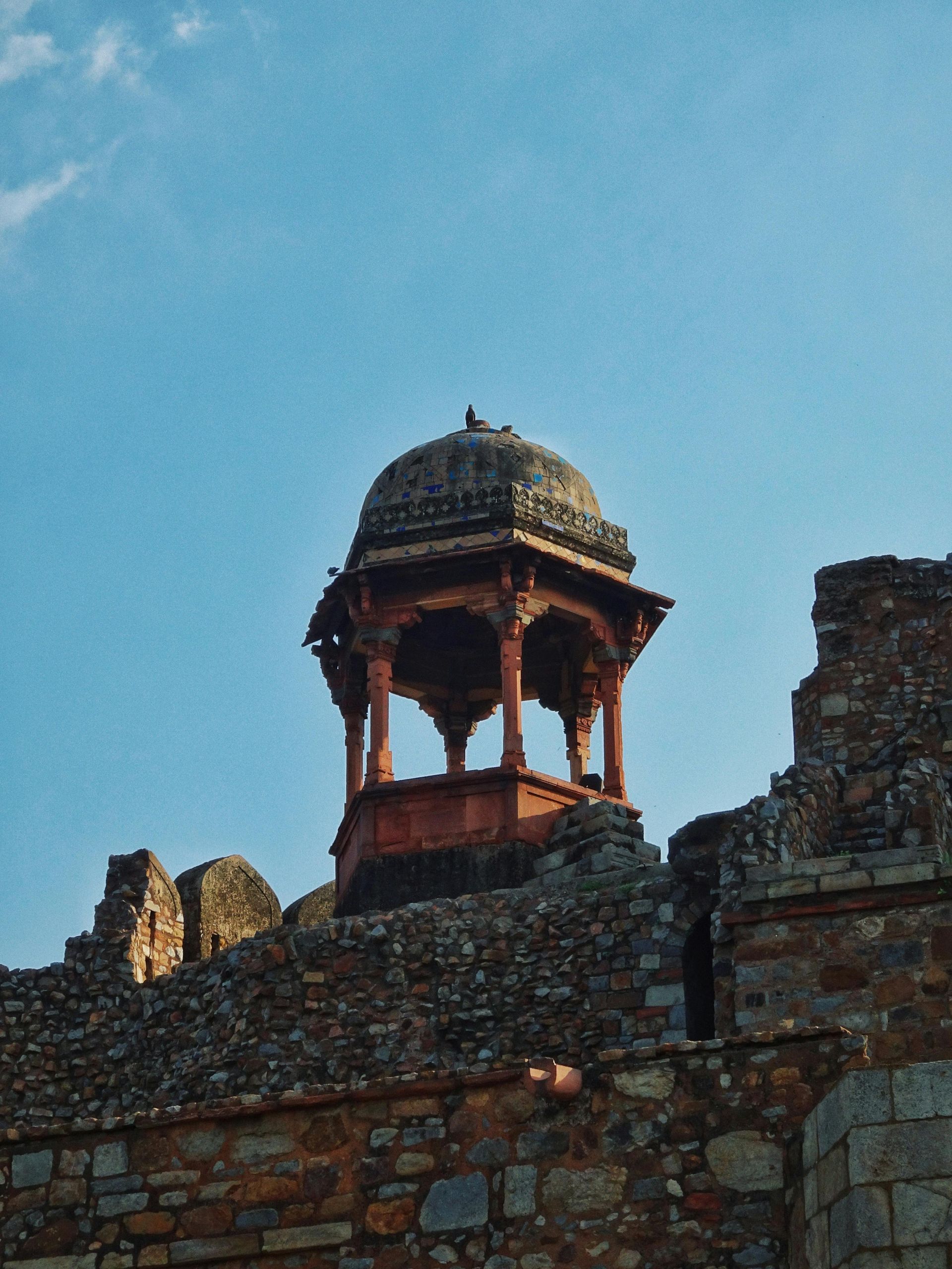 A stone building with a dome on top of it