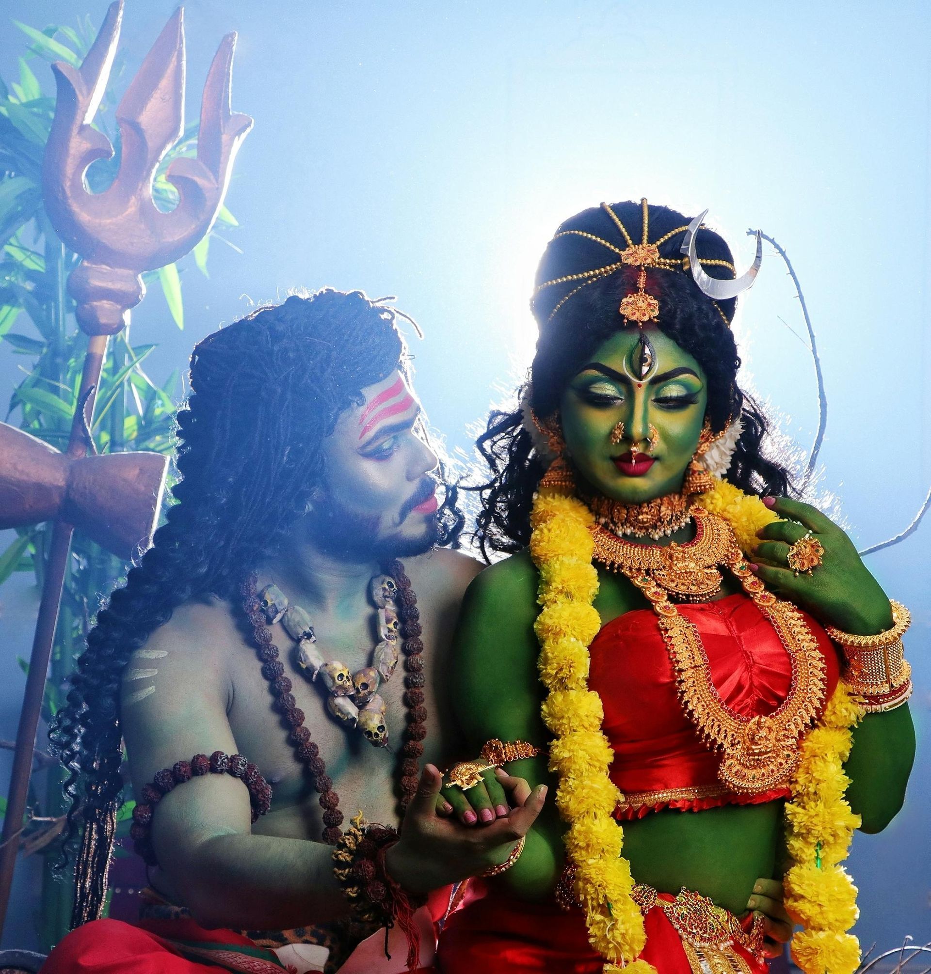 A man and a woman with green faces are posing for a picture