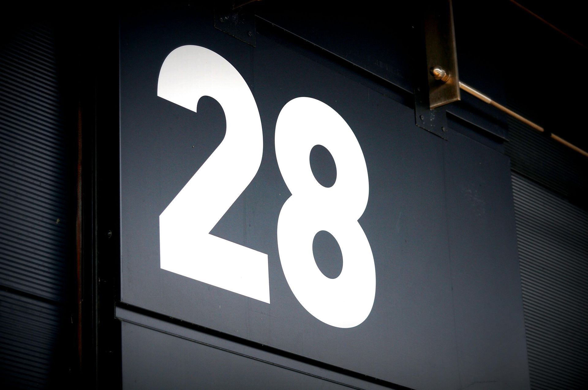 A black sign with the number 28 on it