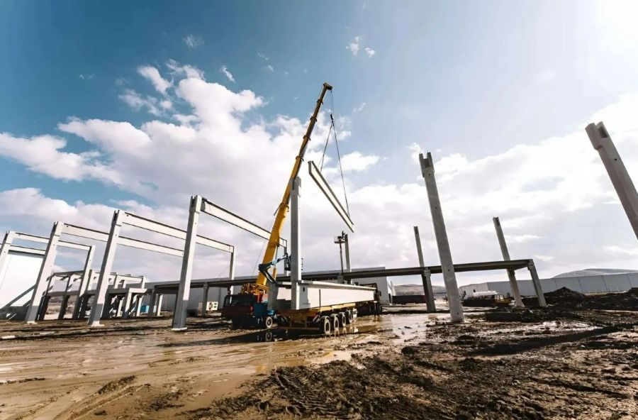 A Crane is Lifting a Beam on a Construction Site — Dubbo Hardcore Soils & Earthmoving In Dubbo, NSW