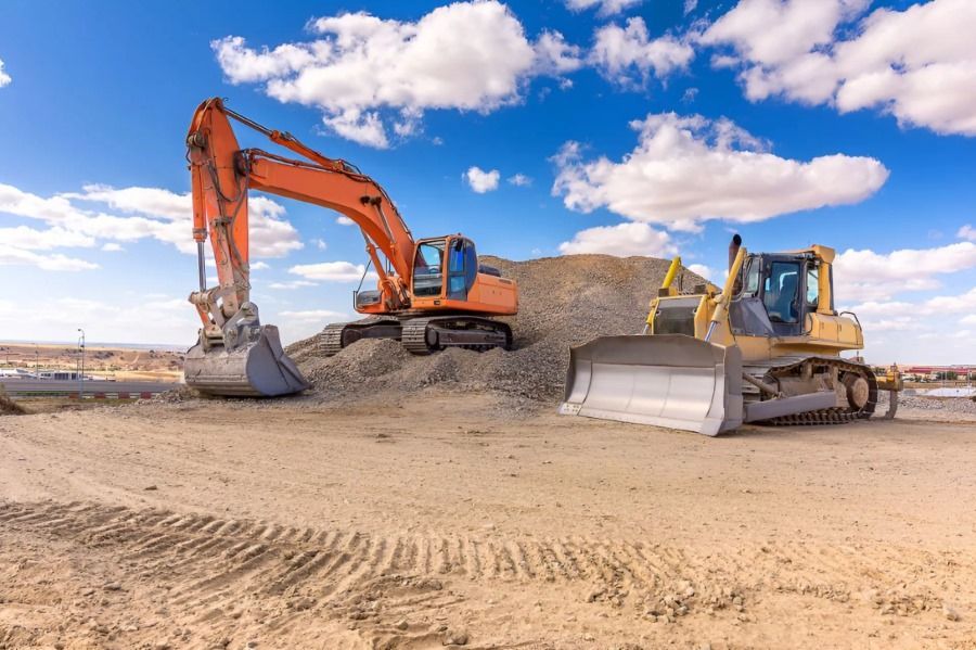 A Bulldozer and an Excavator Are Working on a Construction Site — Dubbo Hardcore Soils & Earthmoving In Dubbo, NSW