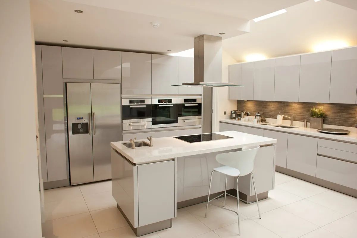 A kitchen with white cabinets and stainless steel appliances