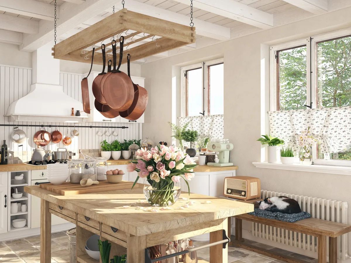 A kitchen with a wooden table and a vase of flowers on it.