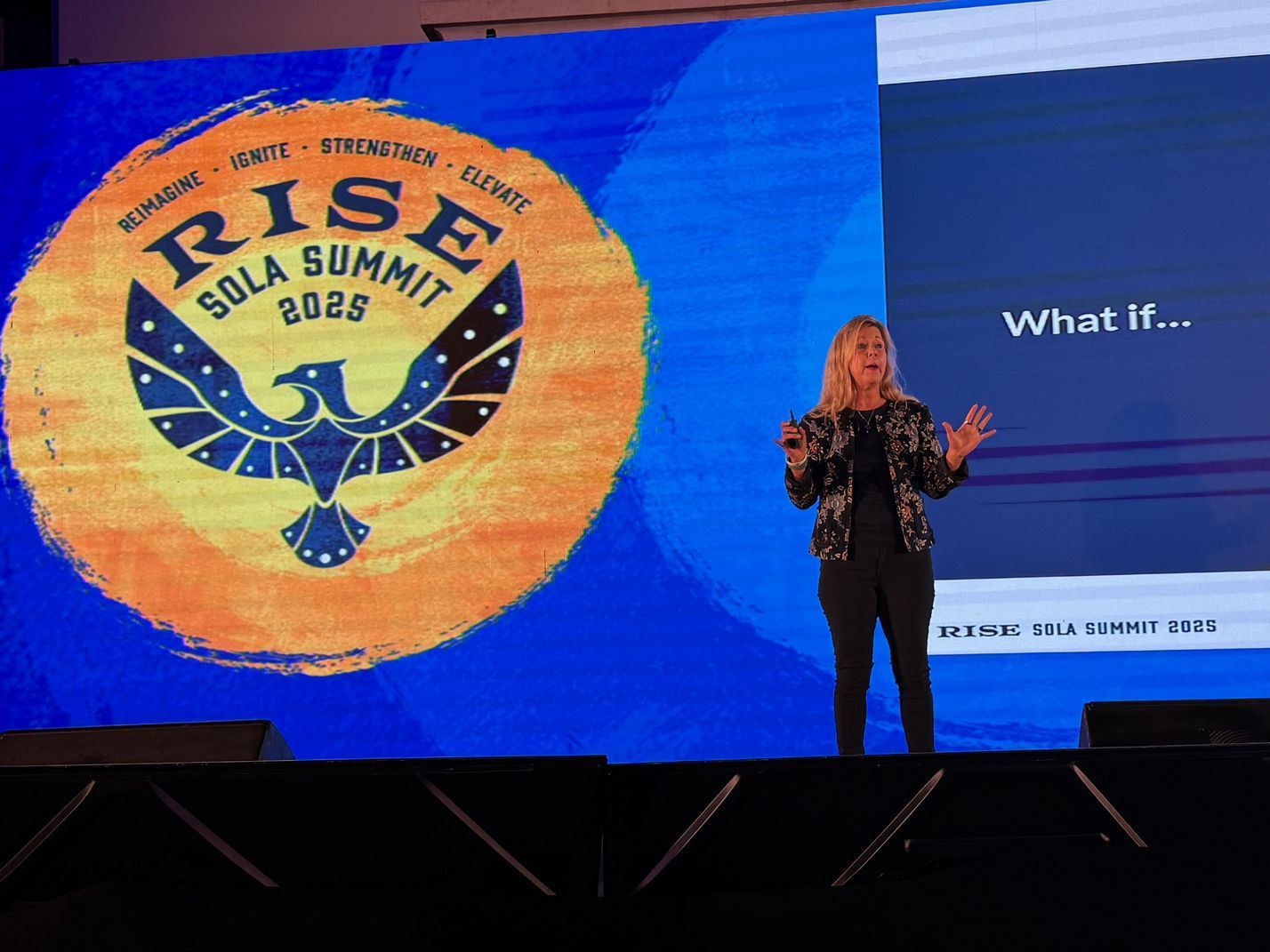 Businesspeople shaking hands, smiling, in a modern office setting.