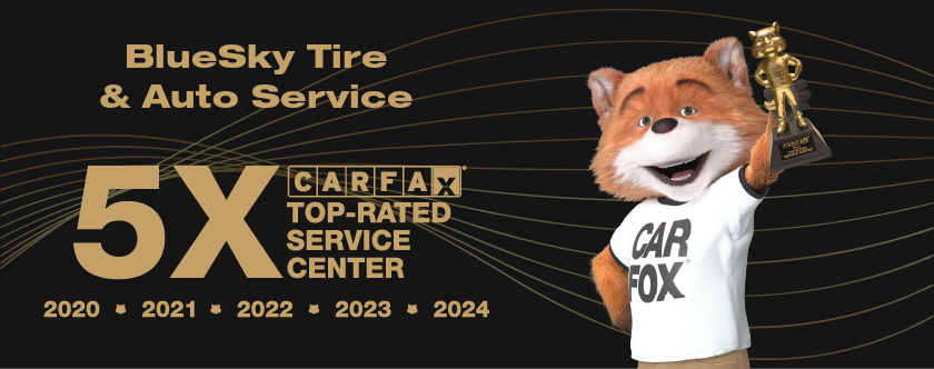 A fox mascot is holding a trophy in front of a blue sky tire and auto service logo.