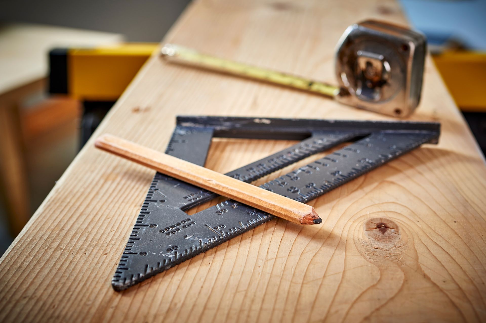 Various woodworking tools laid out on a wooden workbench.