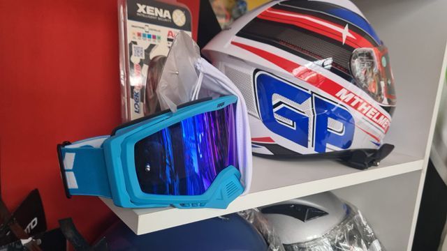 Un casco y gafas están sobre un estante.