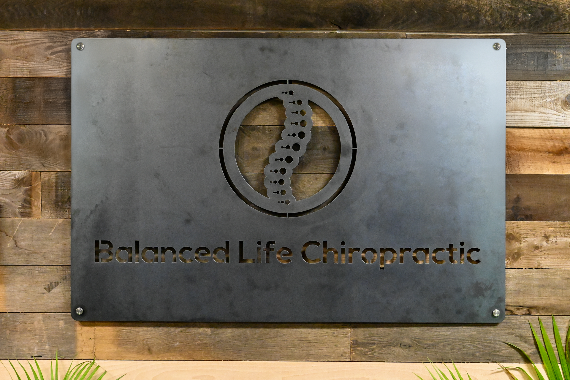 Metal Board that has the Balanced Life Chiropractic logo