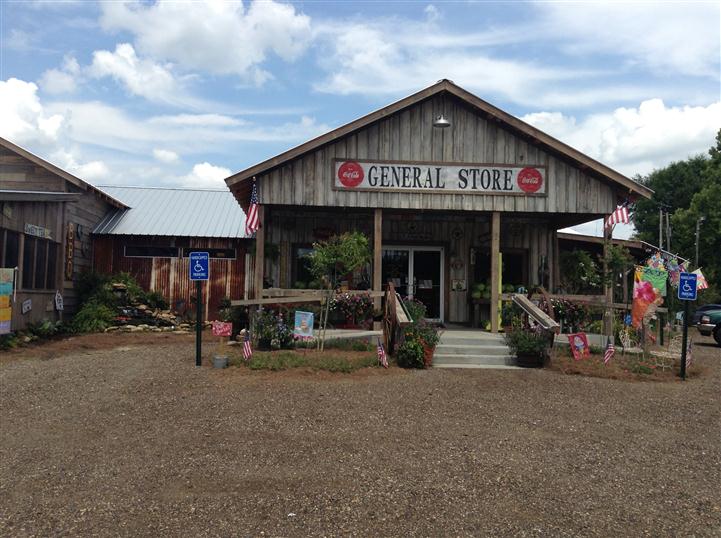 Front entrance of general store with parking lot and American flag